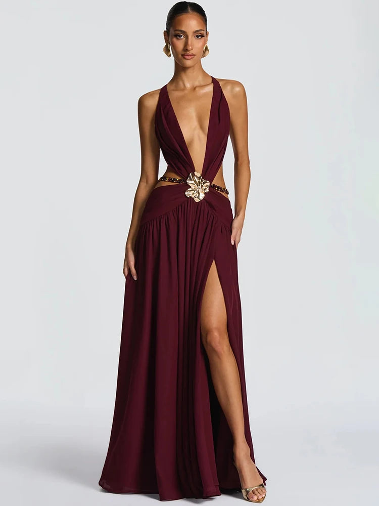 Woman wearing a deep V cutout maxi dress with metal buckle detail
