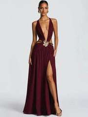 Woman wearing a deep V cutout maxi dress with metal buckle detail
