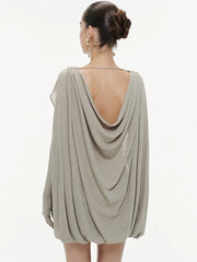 Close-up of the deep V neckline with layered draping across the bodice, showing clean folds and a refined, sculpted finish.