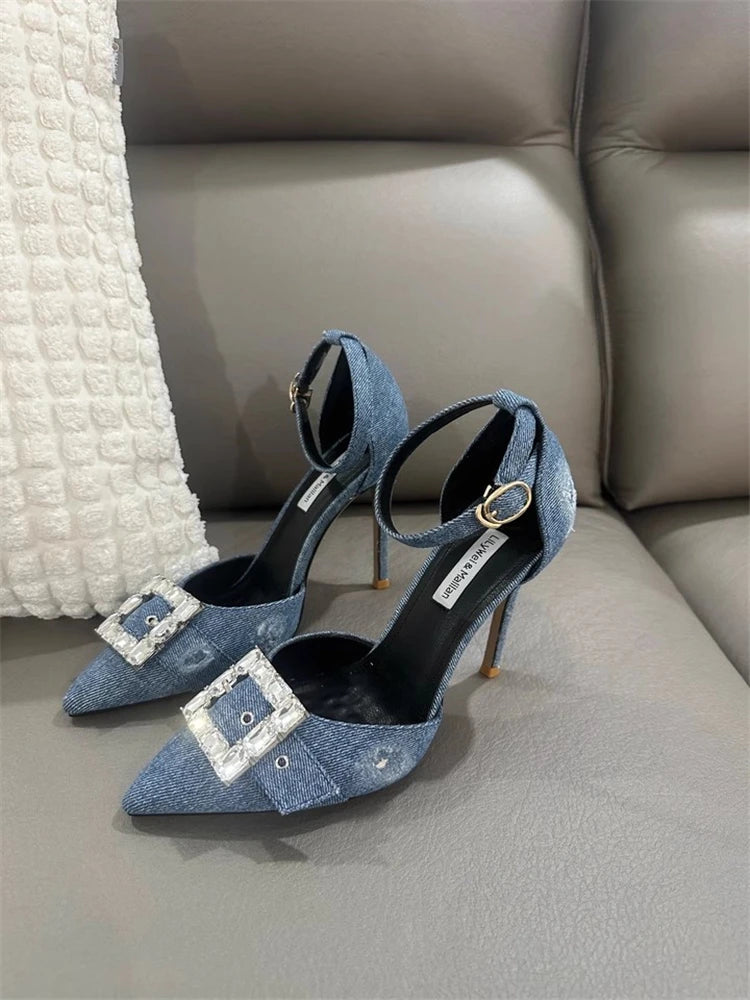 A close-up of the denim and crystal detail on the shoe.