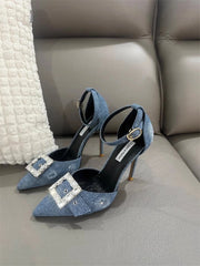 A close-up of the denim and crystal detail on the shoe.