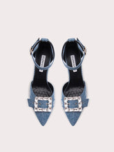 Pair of denim high heels with crystal buckles on a white background