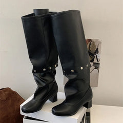 A close-up of the boots showing the detachable rivet cuff and button closure.