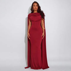 Long cape-draped maxi dress with open-back design
