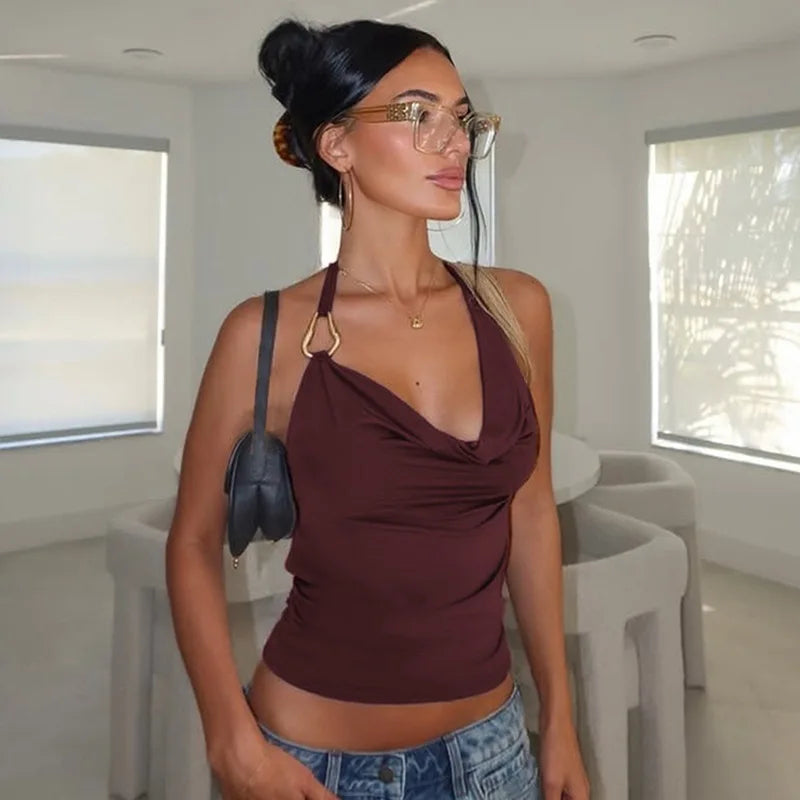 Woman wearing a wine red halter tank styled for Pinterest-inspired streetwear and denim shorts in a modern indoor setting