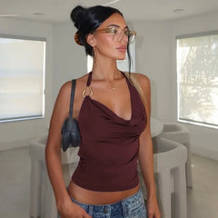 Woman wearing a wine red halter tank styled for Pinterest-inspired streetwear and denim shorts in a modern indoor setting
