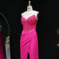 Floor-length fitted gown with draped pleats and elegant slit detail