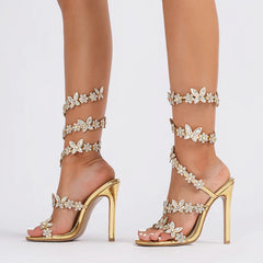The side profile of the ankle-strap sandals showing the butterfly detail.