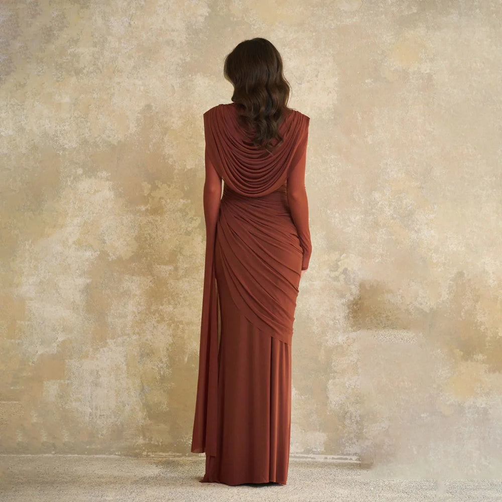 Front angle highlighting the draped bodice and waist shaping, with fluid fabric that falls into a floor-length hemline.