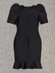 Black dress with puff sleeves on a gray background