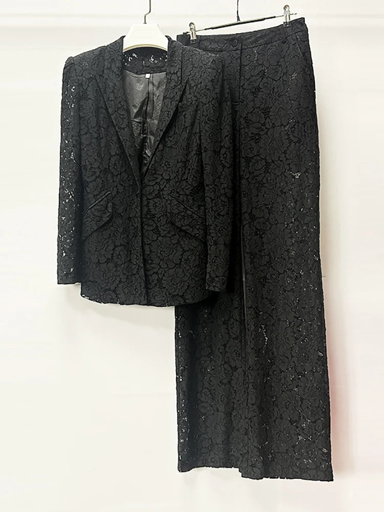 Black textured suit jacket and pants on a white background
