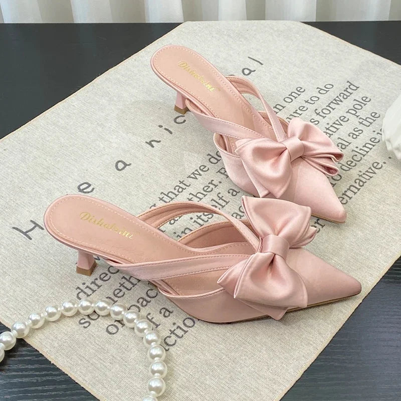 Elegant heeled sandals for women’s outdoor parties and brunches on a textured surface