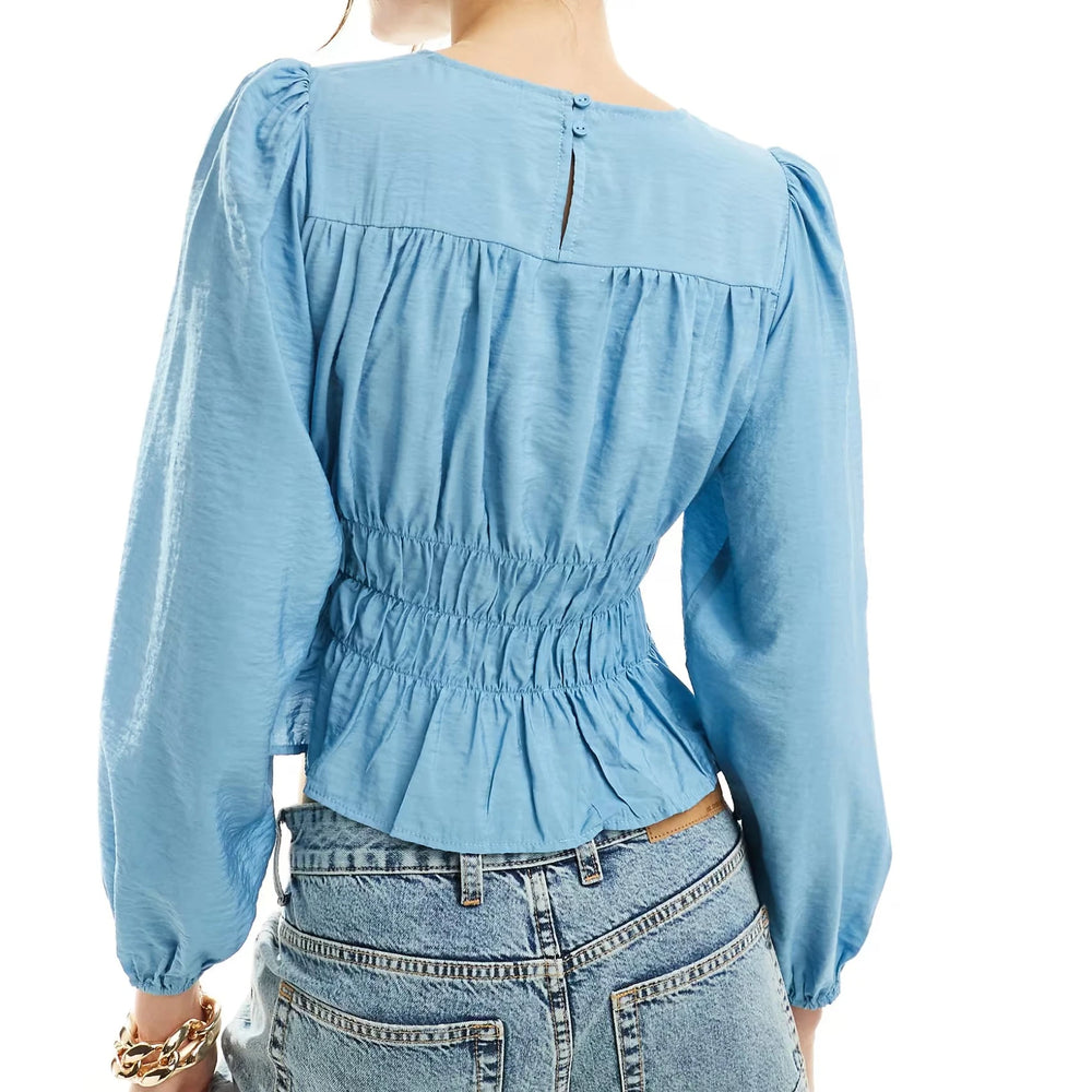 A back view of the elegant long-sleeve round-neck shirt.