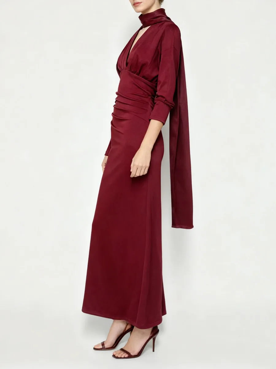 Full-length view of a maroon satin evening dress styled with heels.