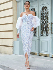 An elegant party gown with a side slit and puff sleeves.