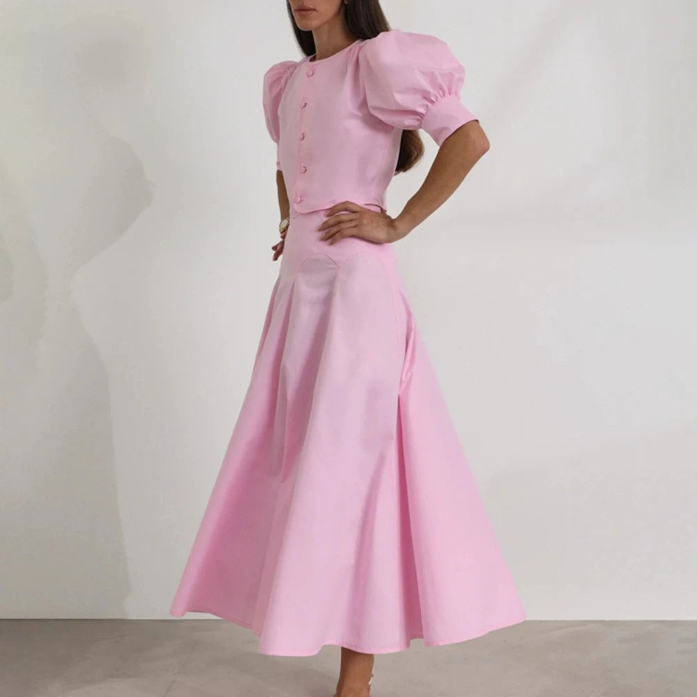 Elegant pink midi dress styled for weddings and formal gatherings