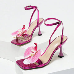 Elegant purple platform gladiator sandals paired for formal wear. Pink high-heeled sandals with floral decorations on a white background