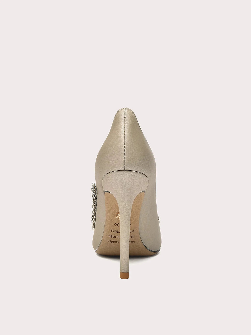 Beige high-heeled shoe with a decorative heel on a white background