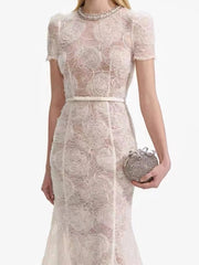 A front view of a women's round-neck belted dress, highlighting the A-line silhouette.