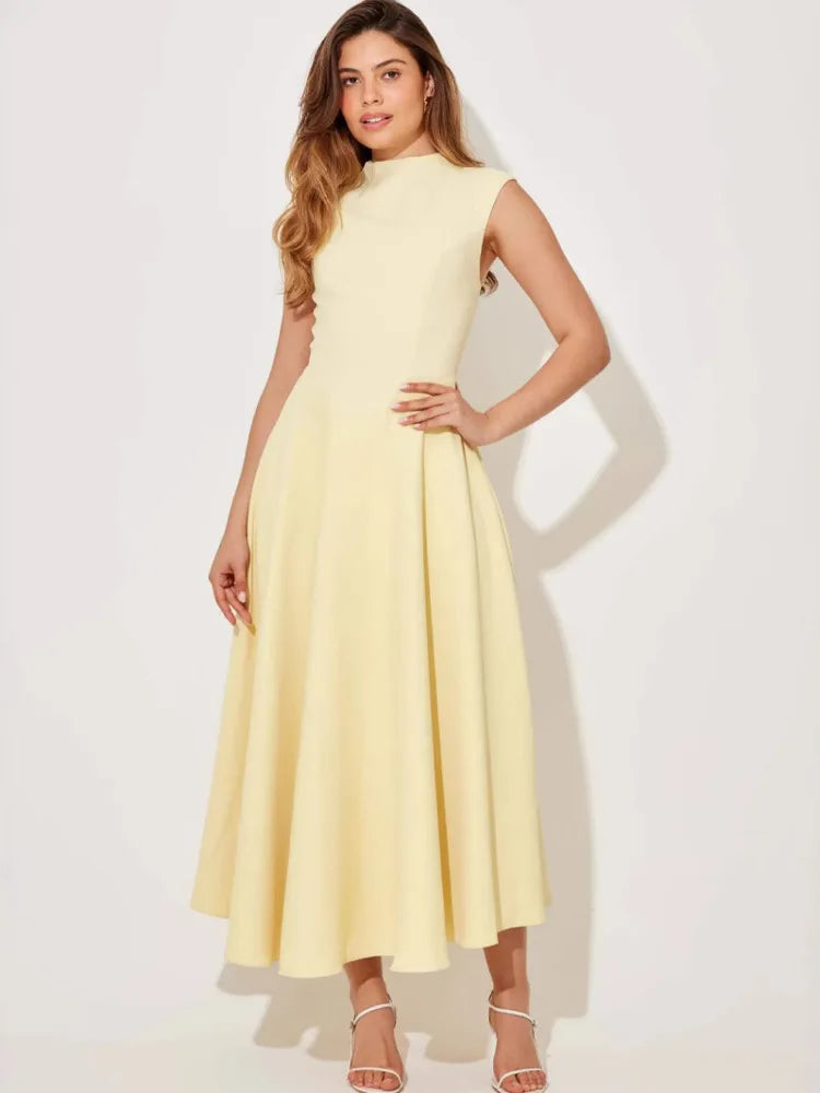 Woman wearing a light yellow dress on a white background