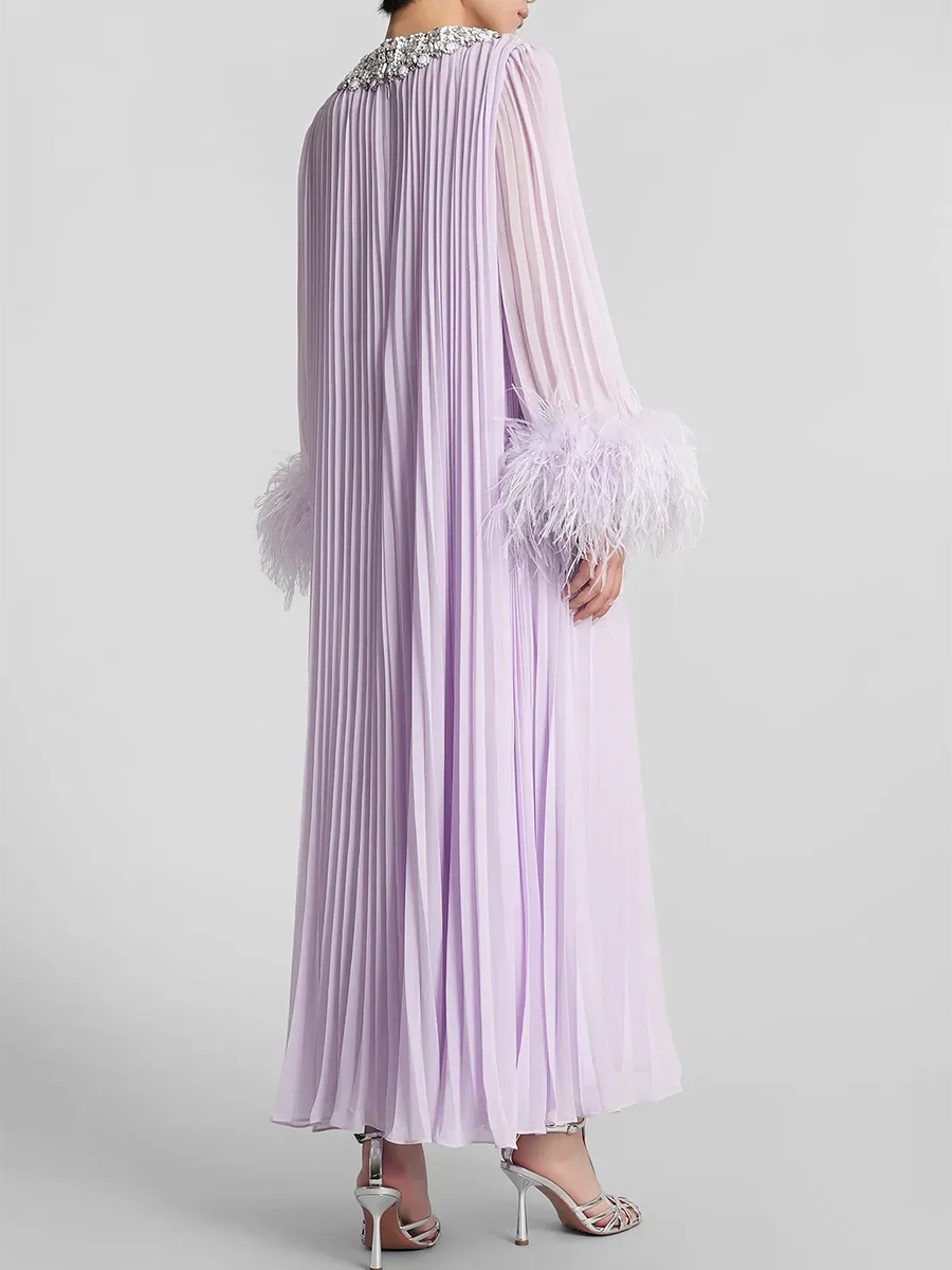 A full-length shot of a slimming feather trim dress, styled for an evening event.