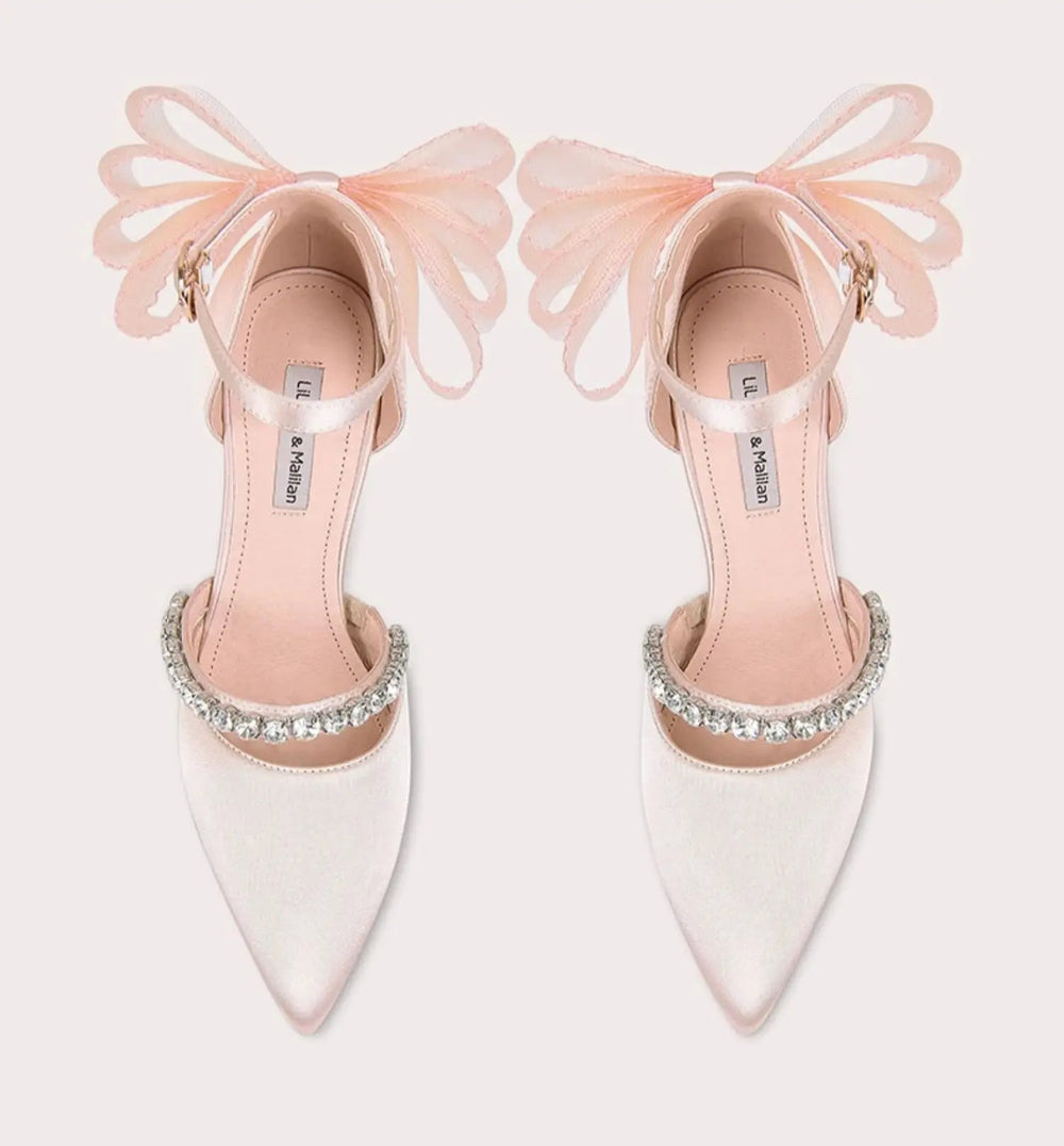 Elegant slip-on stiletto heel available in large and small sizes for women on a light pink background.