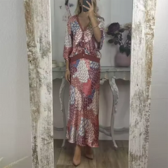 Person wearing a satin floral coord set styled for office-to-evening wear in front of a mirror.