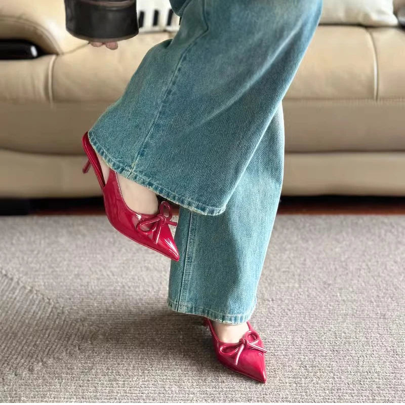 Elegant open-toe red heels with bow detail