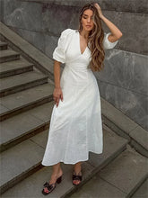 Elegant white midi dress styled on stone steps outdoors