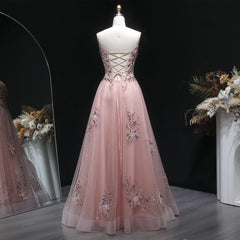 Close-up of appliqué bodice detail on layered tulle gown