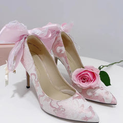 Romantic lace patchwork pink stiletto with butterfly bow for weddings and events, pink rose on a white background