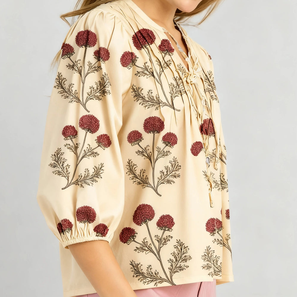 Embroidered long sleeve blouse styled casually with jeans for a relaxed daytime look.