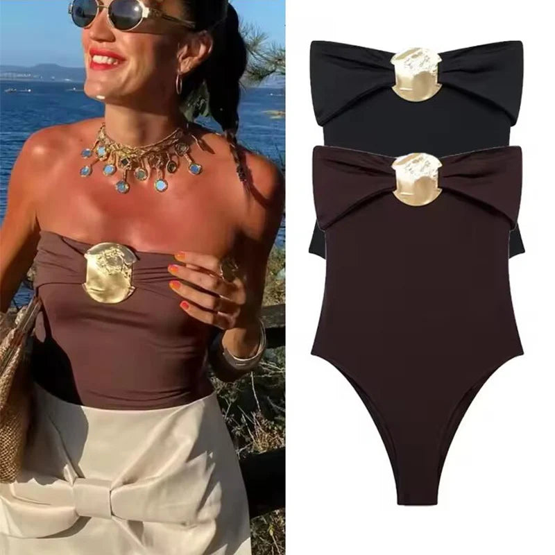 Studio flat lay showing the sculpted neckline fold and centered hardware detail, emphasizing the bodysuit’s sleek, high-street look.