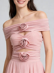 Statement off-shoulder top styled for evening wear with sculptural 3D rosettes