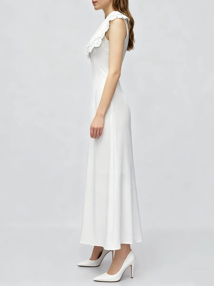 Close-up of the eyelet collar detail on a white summer dress.