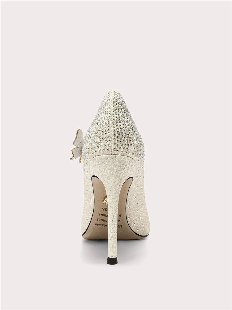 White high-heeled shoe with decorative elements on a light gray background