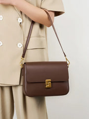 Vintage-style shoulder bag with structured square silhouette and flap