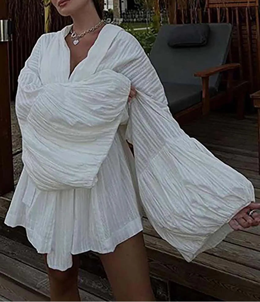 Floaty white summer suit shown as casual beach or brunch wear