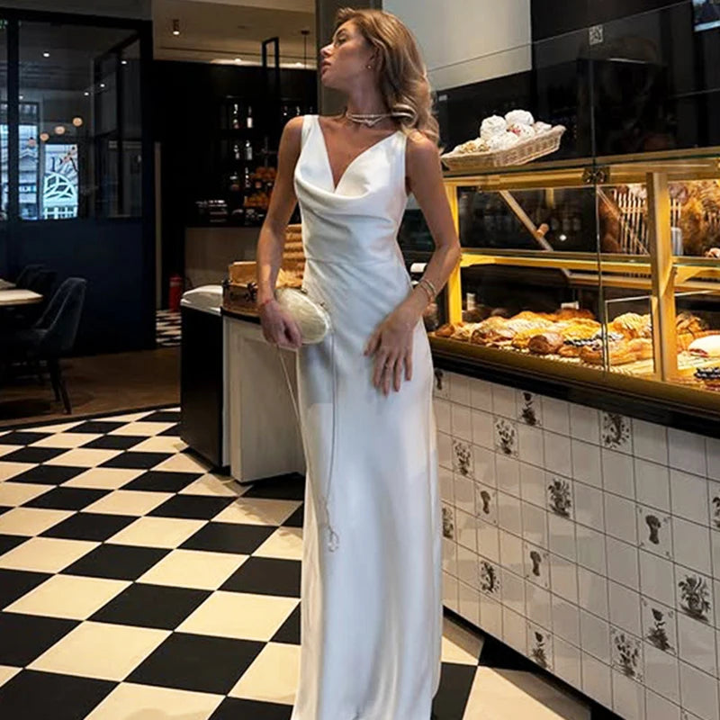 Floor-length elegant white gown with soft drape and modern fit