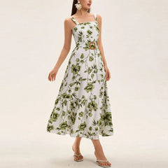 Woman wearing an A-line floral maxi dress perfect for vacation or warm-weather events with green flowers on a white background