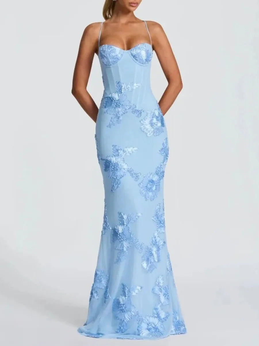 Close view of floral embroidery accents on a light blue formal maxi dress
