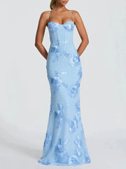 Close view of floral embroidery accents on a light blue formal maxi dress