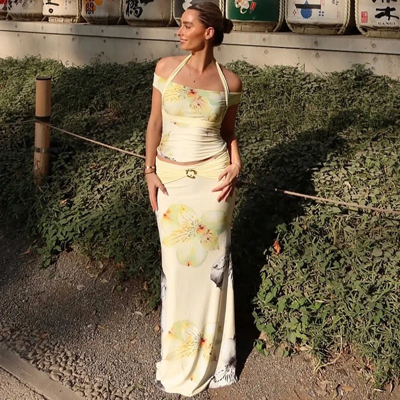 Woman in a floral halter crop top and maxi skirt styled for modern resort days