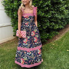 Detail of shoulder ties and lace trim on floral cami dress