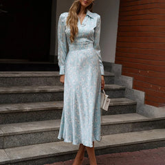 Woman in an Office-ready floral midi dress with a structured collar, standing on the steps.