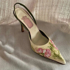 Floral embroidered shoe on a textured fabric background