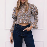 Woman wearing a floral long sleeve ruffled blouse with denim