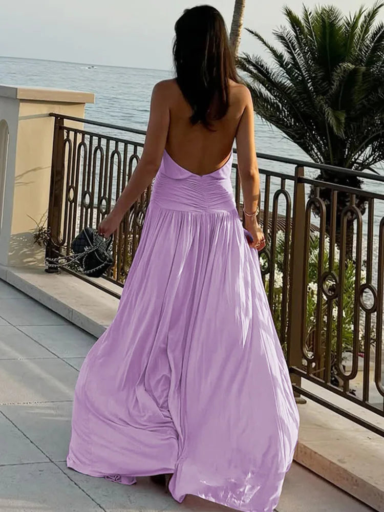 Flowing purple maxi dress on the balcony with sea-view