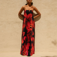 Woman wearing a lightweight pleated maxi dress against a beige wall.