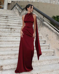 Formal burgundy halter gown styled on outdoor stone steps
